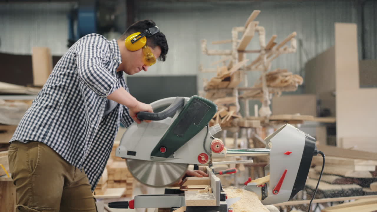Carpenter using a circular saw in a workshop