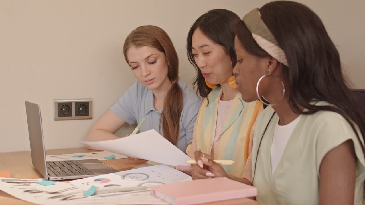 Fashion Designers Discussing over Sketches