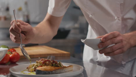 drizzling olive oil-herb mixture over salmon steak