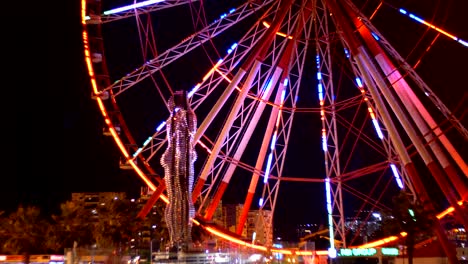 statue of ali and nino on a background ferris wheel at night on the embankment of batumi, georgia