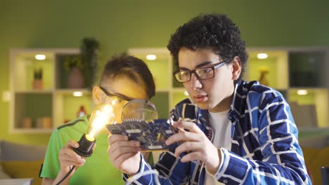 At-home,-two-friends-are-examining-a-piece-of-technological-computer.