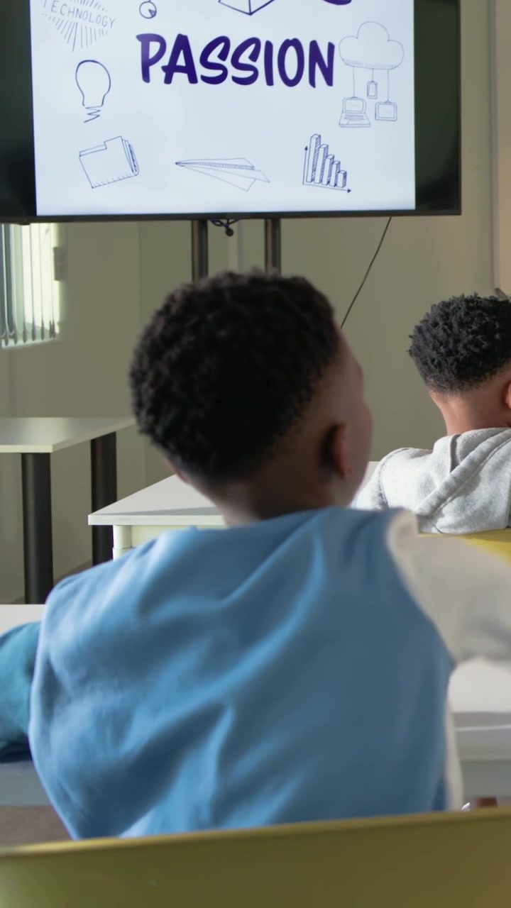 Vertical video: Seeing PASSION slide in class pupil in blue white top raising hand signaling answer