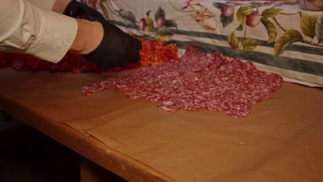 Time-lapse-of-chef-laying-out-salami-Napoli-meat-snacks-on-outdoor-catering-table-at-night