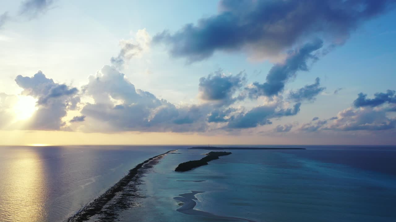 Cinematic sunrise over the open ocean near Barbados. Colorful horizon, sun reflecting on the calm water surface