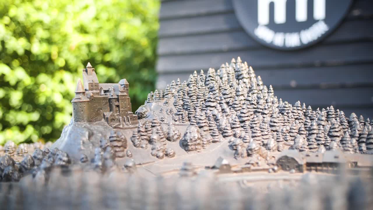 Detailed closeup of miniature replica showing castle and trees from carved out medium