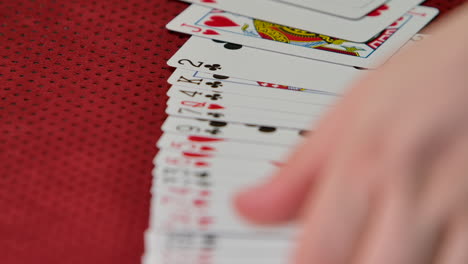 Slow-motion-shot-of-a-casino-dealer-spreading-a-deck-of-cards