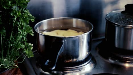 boiling potatoes for a dinner with parsley in the scene