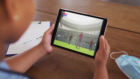 composite of woman on couch at home watching rugby match on tablet