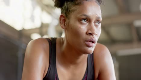 tired african american woman resting after training at gym in slow motion