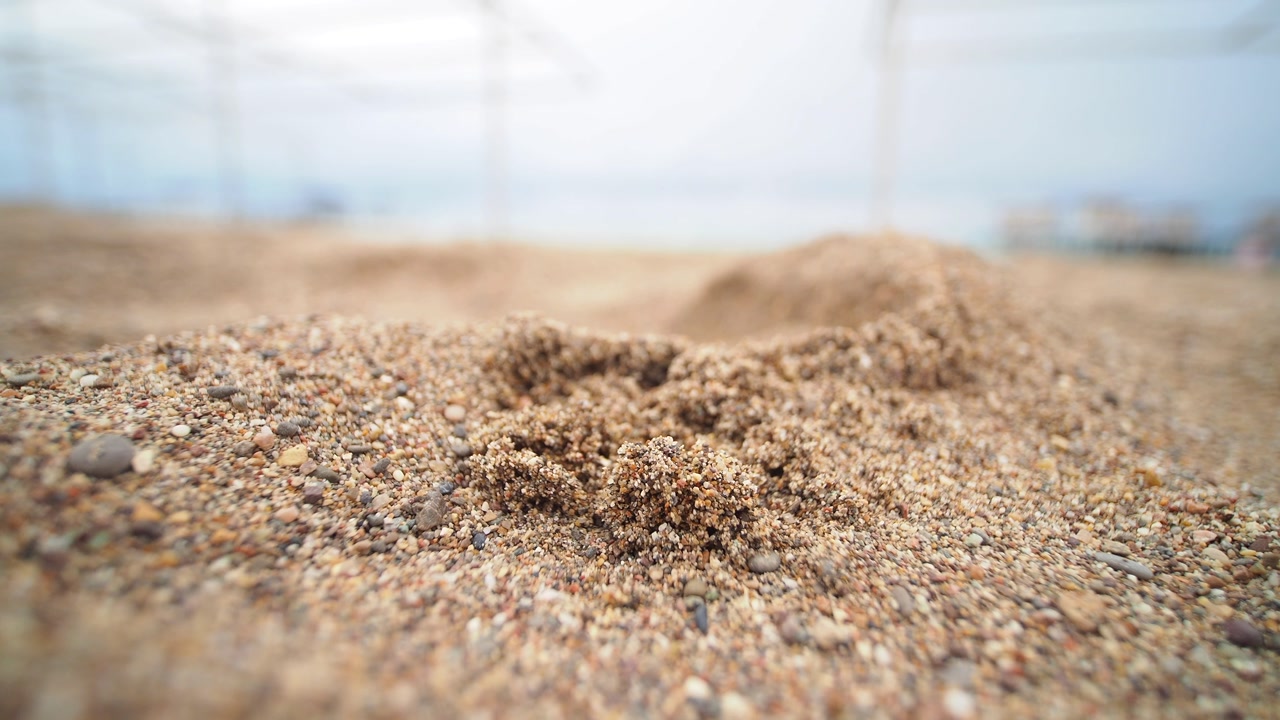 Detailed View of Shifting Sand and Small Pebbles