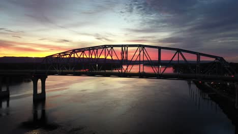 sunrise or sunset over a river with bridge