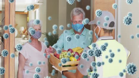 Animation-of-covid-19-cells-over-senior-couple-and-delivery-man-in-face-masks