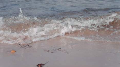 ocean waves crashing on the beach on a sunny day