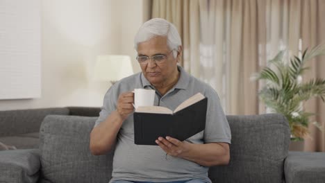 Indian-old-man-reading-book-in-morning