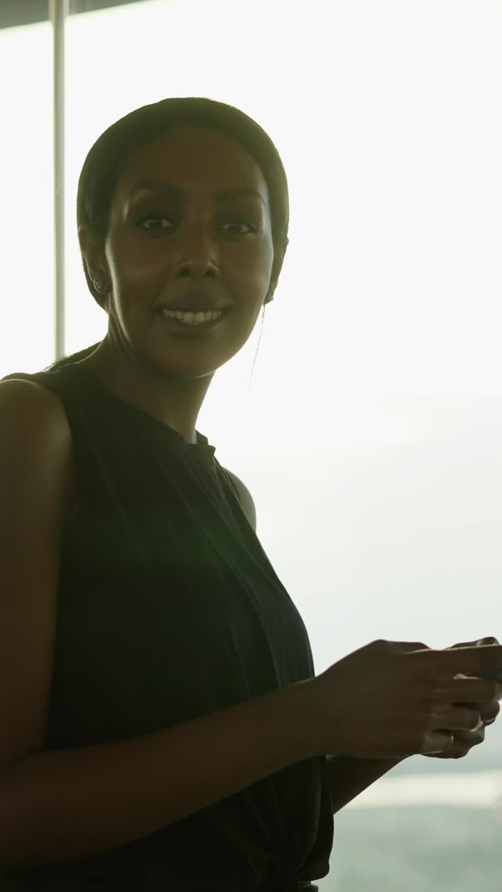 Woman interacting with her smartphone in a bright room