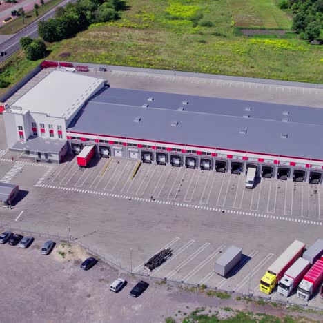 aerial view of a distribution center with loading docks and trucks
