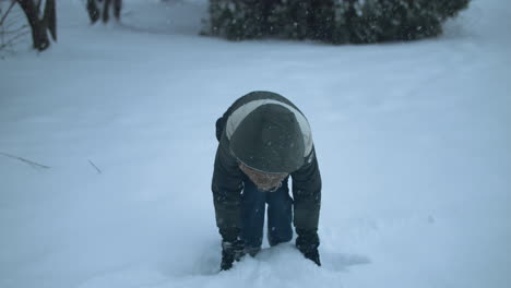 happy kid on christmas morning playing in snow