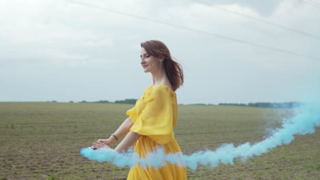 joyful female whirling in colored smoke outdoors