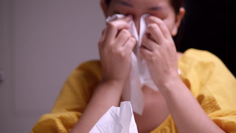 picking some tissue to wipe off the tears from her eyes, the woman is sobbing and in real deep sorrow