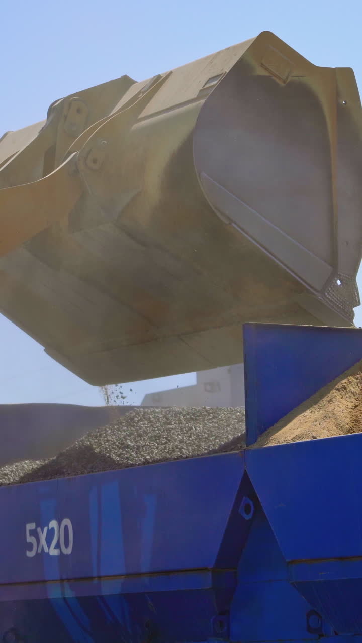 Equipment for production of asphalt. Asphalt mixing plant pouring asphalt in to truck in factory industrial