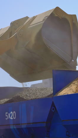 equipment for production of asphalt. asphalt mixing plant pouring asphalt in to truck in factory industrial