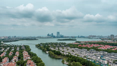 Real-estate-cityscape-and-a-residential-area-concept,-view-drone-hovers-over-a-neighborhood-with-houses,-surrounded-by-tall-buildings-trees