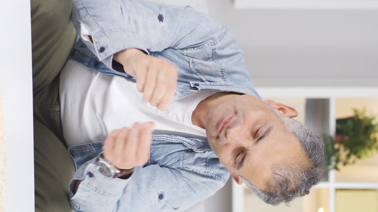 Vertical video of Thoughtful man with a ring in his hand. Separation thought.