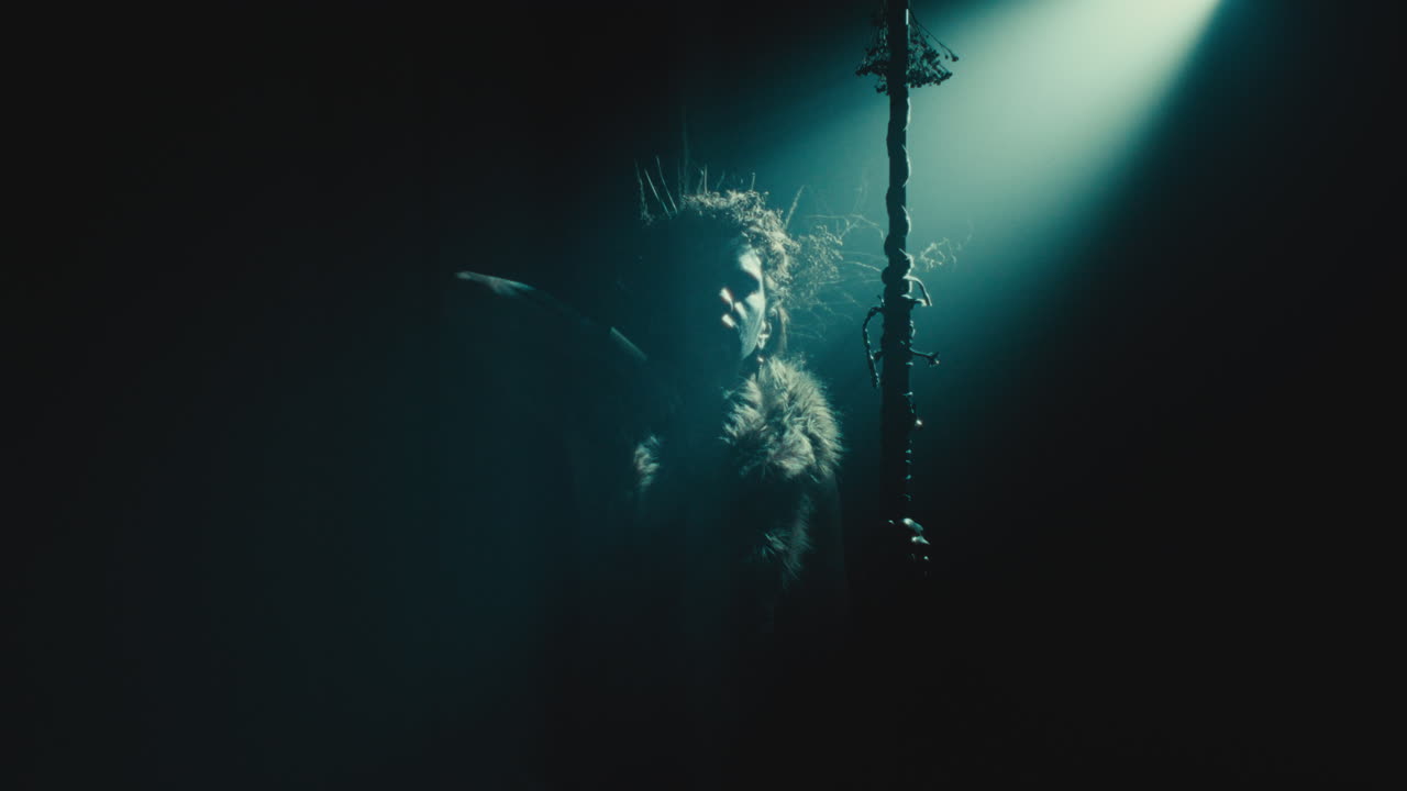 The witch makes a gesture of cutting her throat