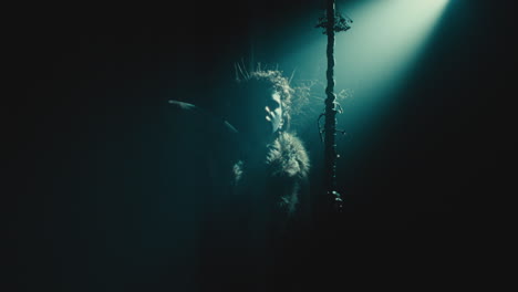 the witch makes a gesture of cutting her throat