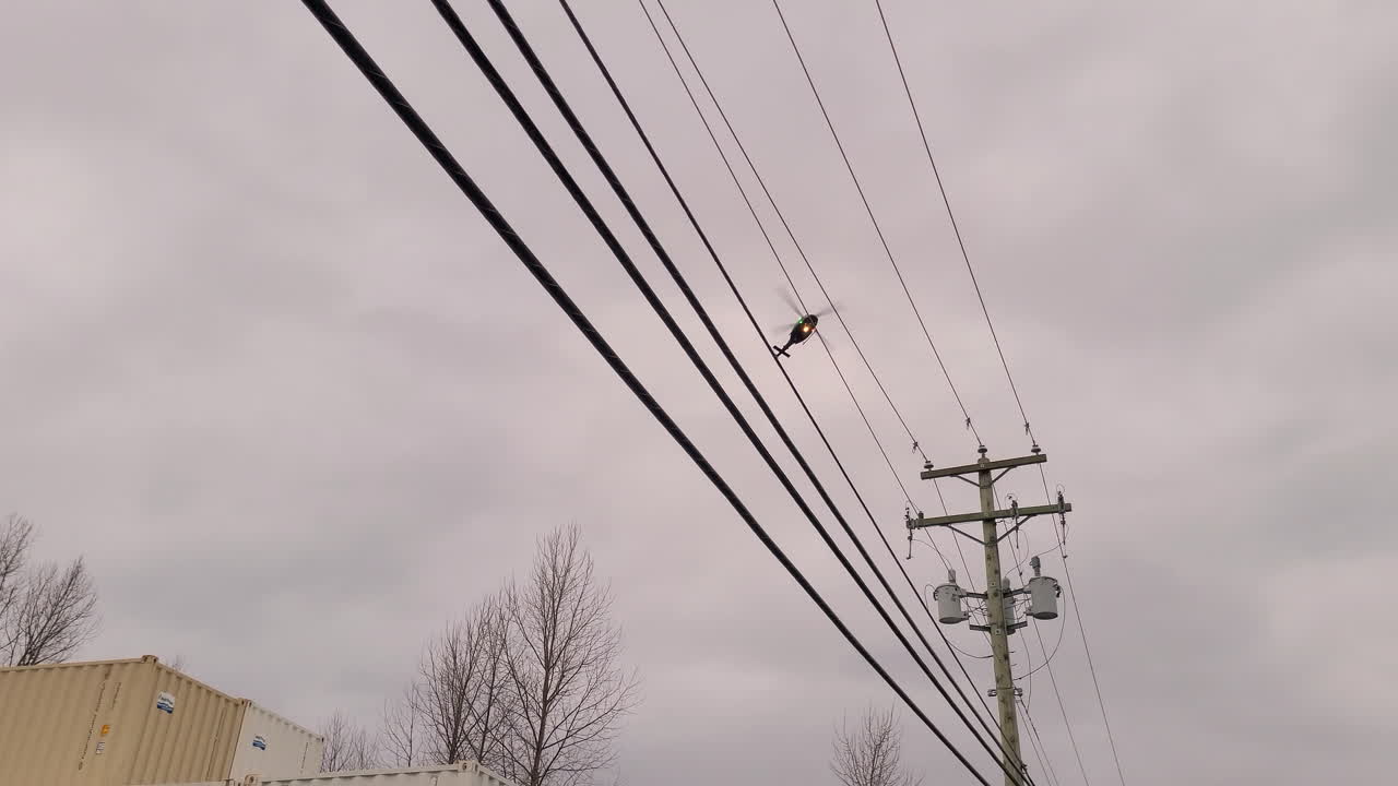 helicóptero volando contra el cielo nublado en abbotsford, canadá