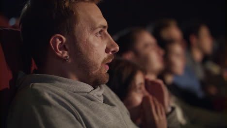 man watching scary movie in the cinema