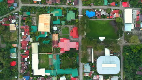 an areal shot of the town center of malitbog, southern leyte, philippines. the center portion is a 16th century church made by the spanish. drone shot a.