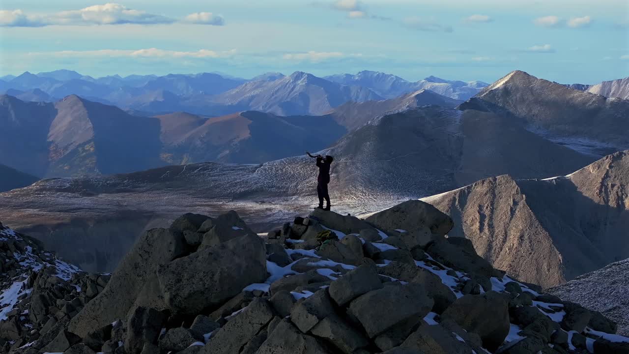 Hikers top of snow covered Mt Mount Shavano Taeguache Peak aerial drone Colorado Collegiate peaks golden hour Rocky Mountains Huron Peak Mt Elbert Sawatch Range fall autumn parallax circle motion