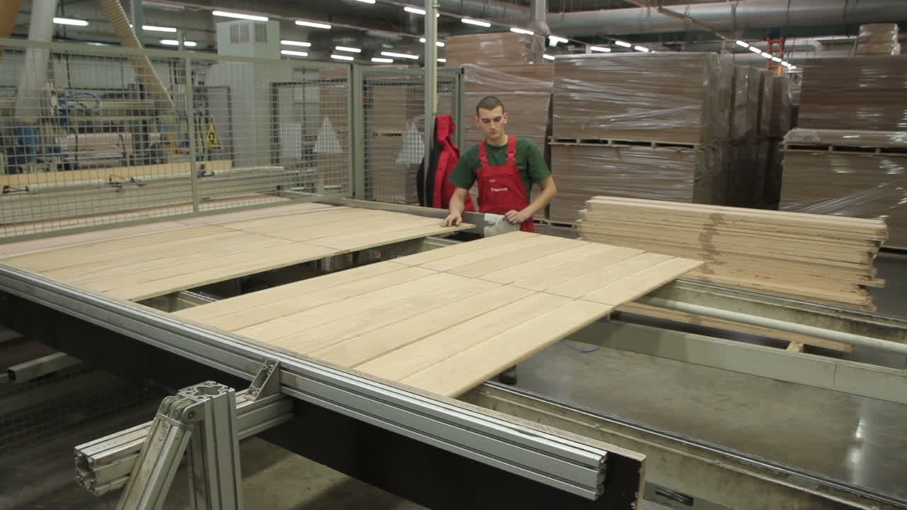 Production Line In Woodworking Factory. Manufacture of flooring, parquet processing
