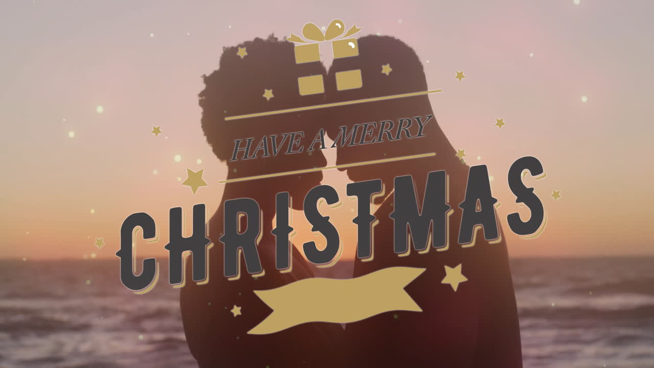 At sunset, silhouetted couple with animation of Have Merry Christmas text