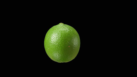 single lime on black background