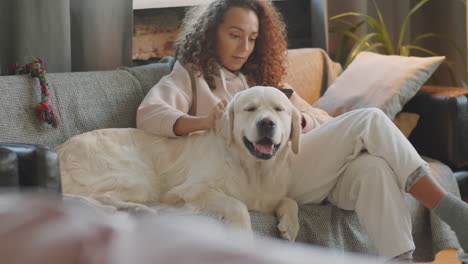 woman relaxing with her dog on the couch