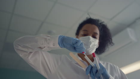 african nurse preparing cotton swab to collecting antigen tests close up.