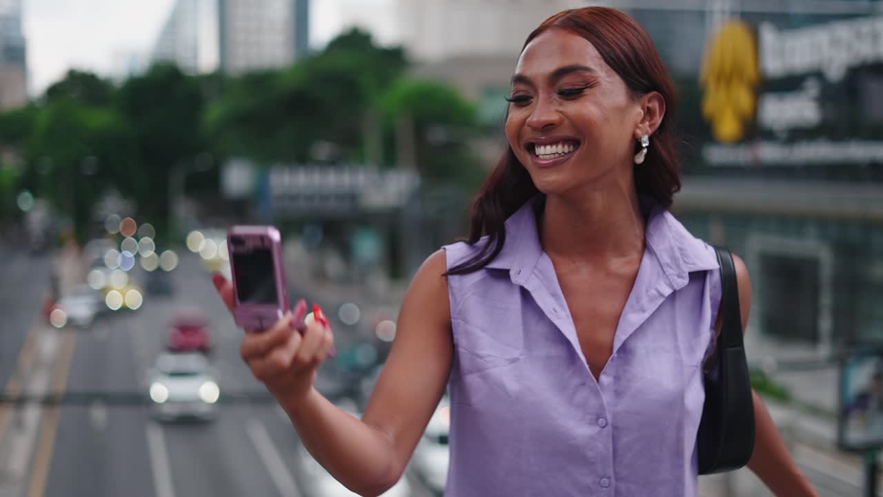 Smiling Woman Taking a Selfie on a City Bridge