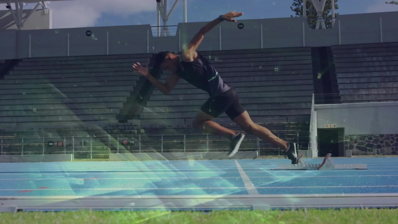 Sprinter shifting weight driving from blocks starting on blue track with flares overlaying runner