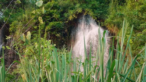 Beautiful-Great-Waterfall-that-flows-down-the-mountain-is-lit-by-the-evening-sun