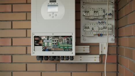 an electrician installing an inverter in a home. the image shows technical skill, modern tools, and attention to safety in electrical work