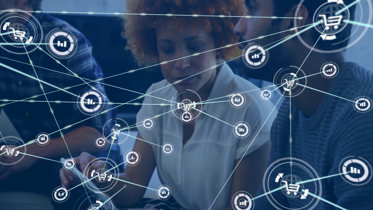 Woman tapping tablet and team tracing data while shopping cart icons linking in technology meeting