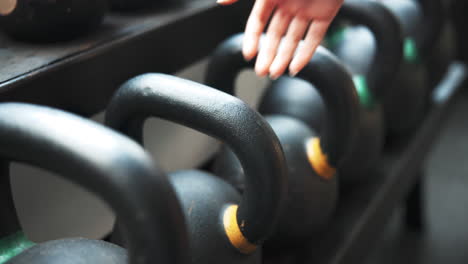 Weights,-closeup-and-hand-at-the-gym-for-lifting