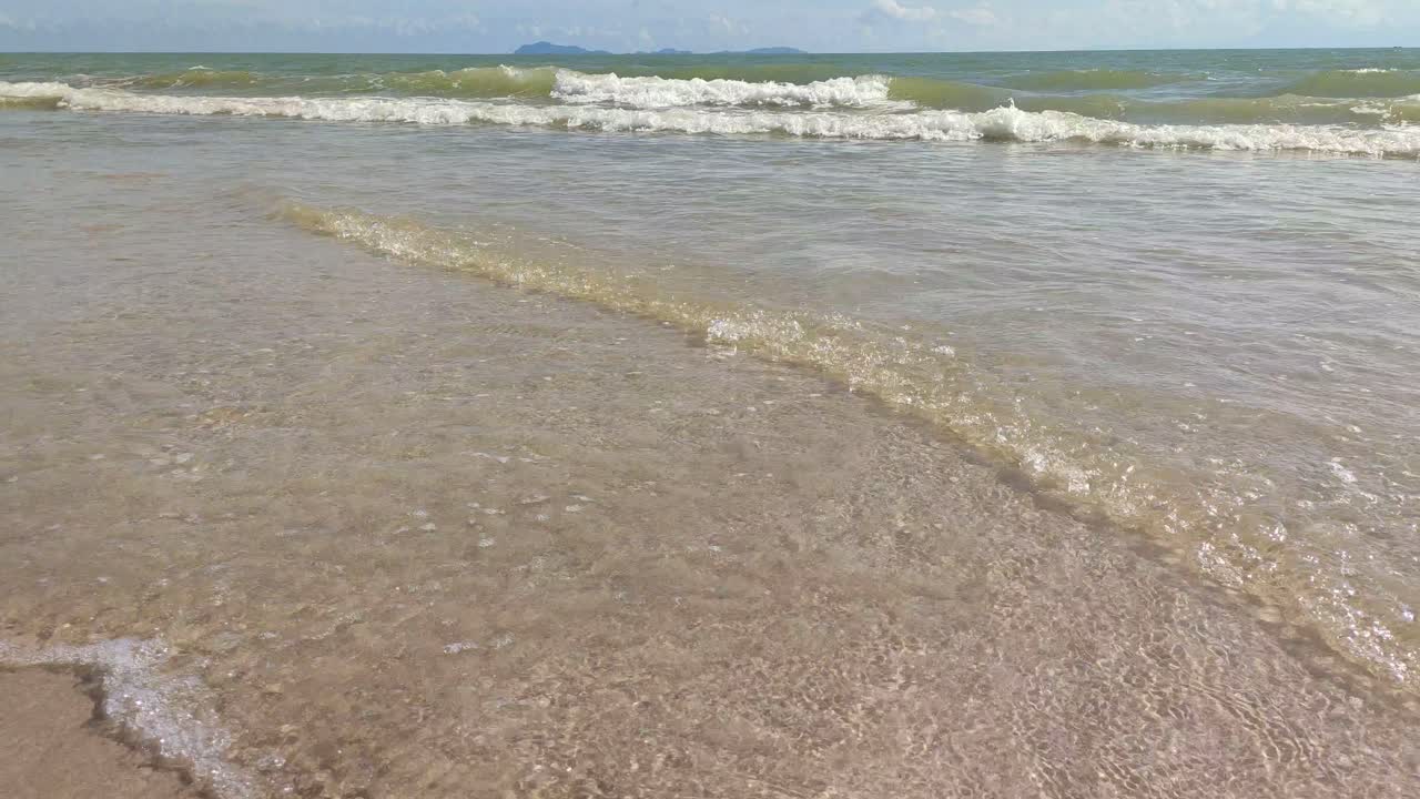 Serene Beach Scene: Calm Waves and Clear Water