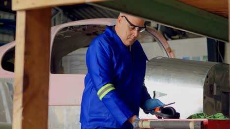 engineer using digital tablet in aircraft hangar 4k