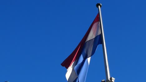 flagpole of the netherlands waving in the wind