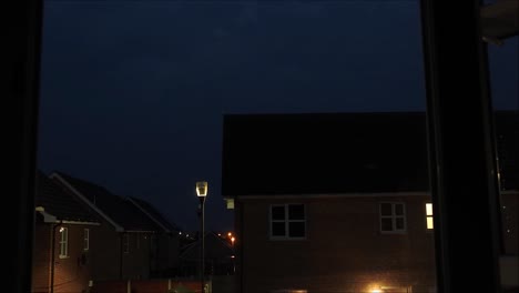 A-timelapse-of-clouds,-various-shapes-and-colours-passing-over-houses-in-England,-United-Kingdom