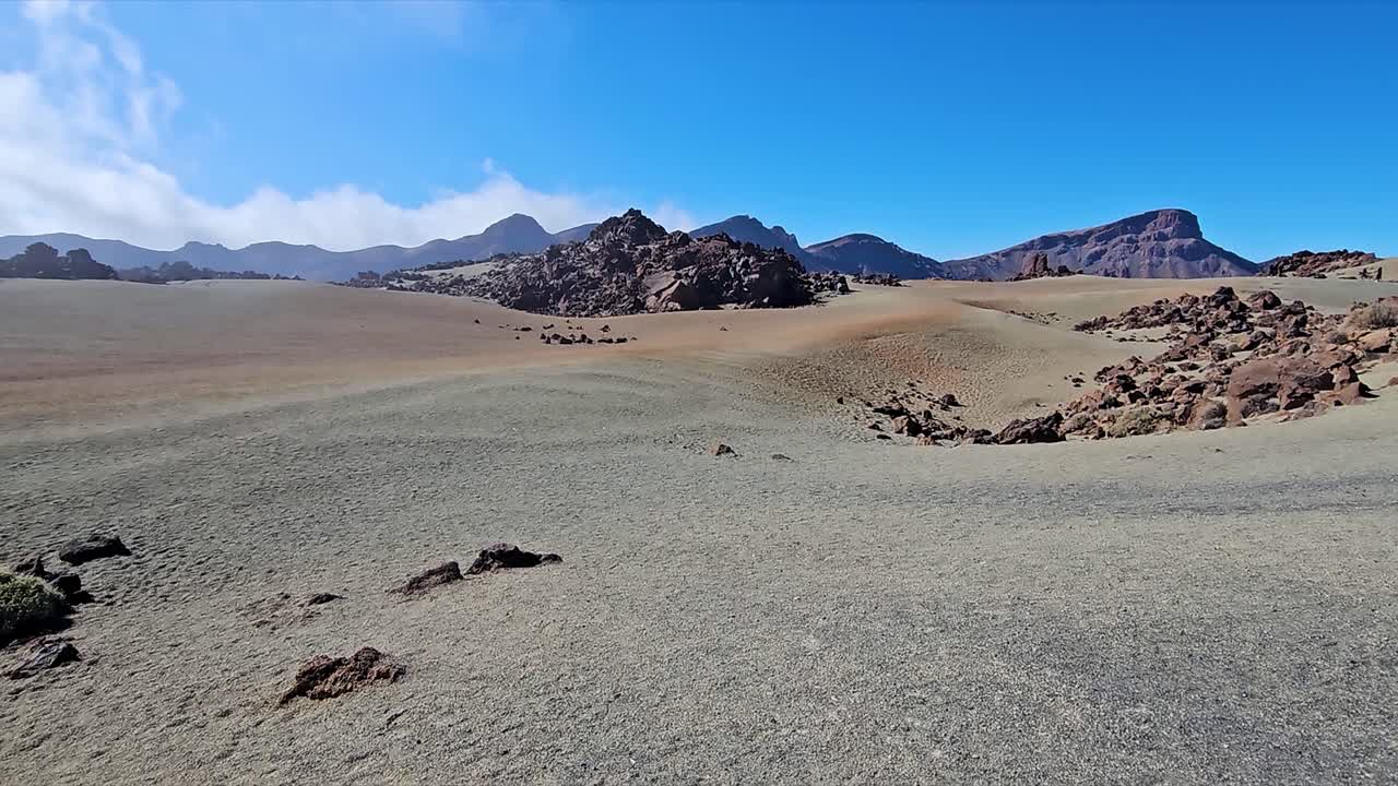 Serene desert-like landscape at Roques de Garcia, Spain, with rocky terrain and clear skies