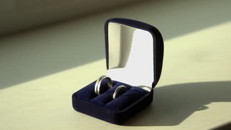 wedding rings in a blue velvet box